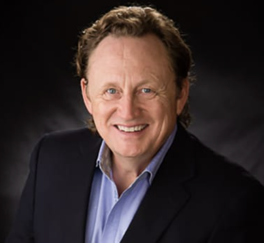 Headshot of Doug Jackson - he is wearing a black suit jacket with a light blue shirt.